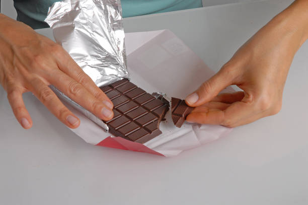 istock opening and breaking dark choclate bar 1740279949