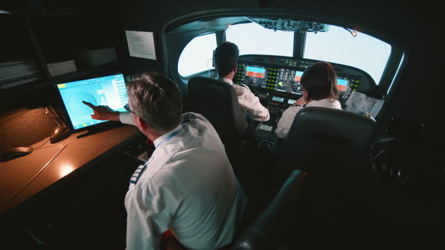 Instructor and pilots in professional flight simulator during flight