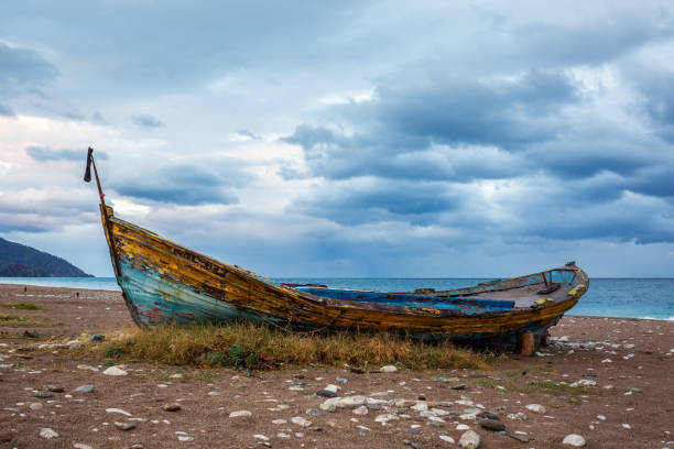 Old abandoned wooden boat on the beach.