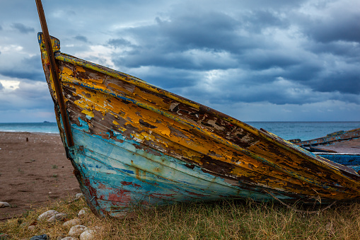 Old abandoned wooden boat on the beach.
