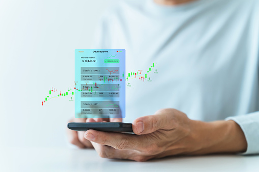Trader using smartphone for trading in stock market. Success idea of online financial and investment growth or increase in saving, profit, earning and wealth. Globalize financial concept.