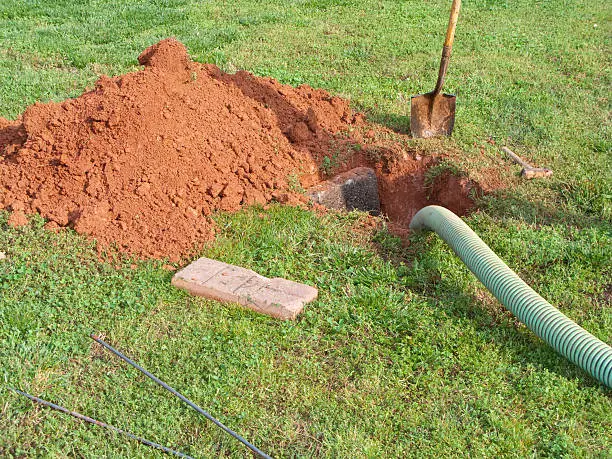 Photo of Open Septic Tank In Yard While Bring Pumped Out