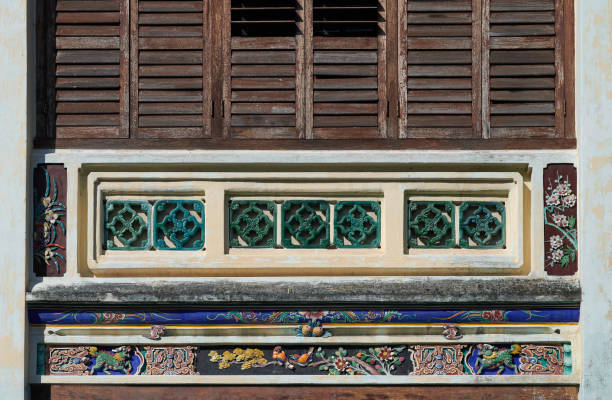 ancient house with traditional decorative in george town. heritage chinese porcelain decor house in penang. vintage wooden louvred shutters. - louvred imagens e fotografias de stock
