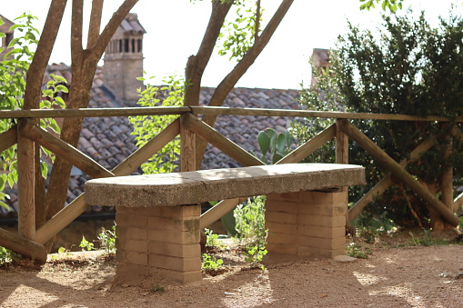 Concrete bench, isolated in a private garden.
