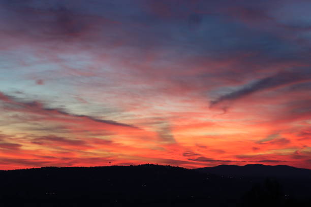 istock Fiery sunset sky over dark countryside 1740353024