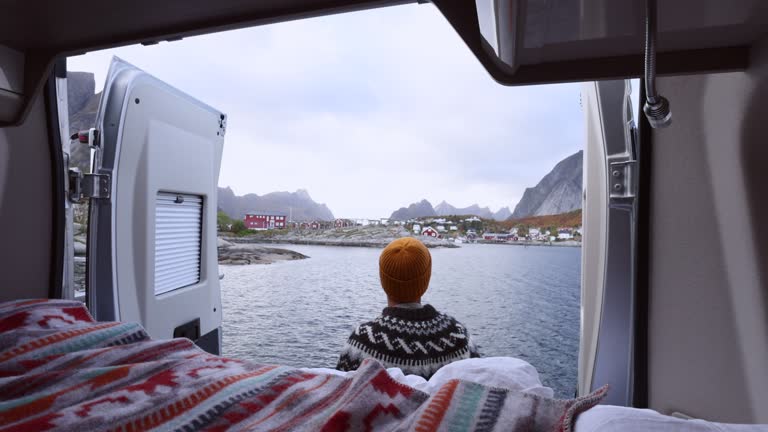 Slow Motion: Man opens camper van door, scenic Norwegian landscape