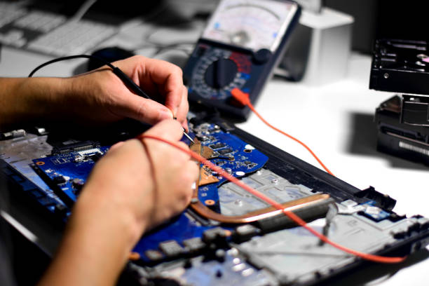 istock A repair technician is using a meter to measure the malfunction of the notebook computer's electronics. Electronic equipment and deterioration and find a way to repair 1740361938