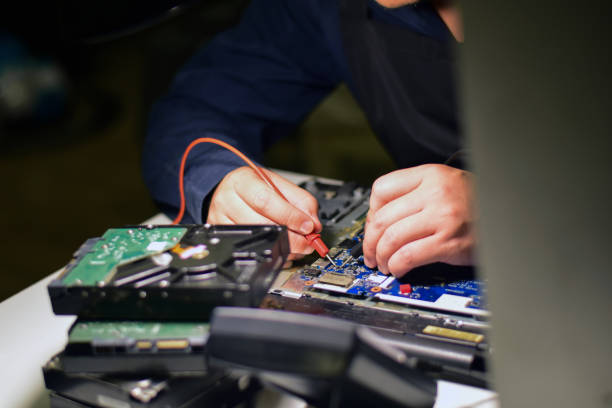 istock A repair technician is using a meter to measure the malfunction of the notebook computer's electronics. Electronic equipment and deterioration and find a way to repair 1740361980