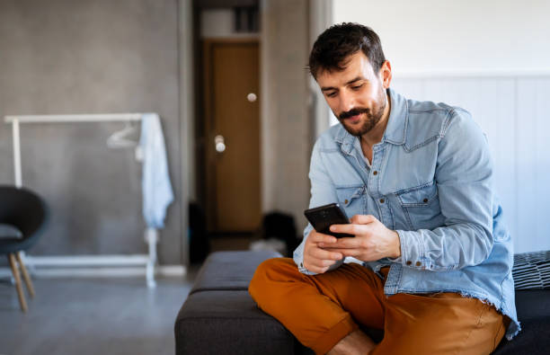 istock Young man using cellphone for work, social media or relaxation. Smart phone people concept. 1740362579