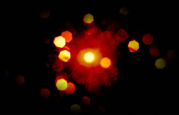 Vector illustration of A horizontal creative glittery dark orange twinkling Diwali or Christmas bokeh lights empty blank sparkling soft focused Xmas vector backgrounds with shining glitter effect and a sunburst in backdrop