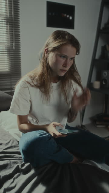 Angry Girl Texting on Phone in Bedroom