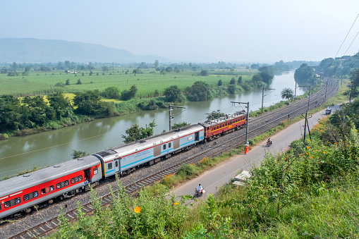 Pune, India - October 15 2023: WCAM2P electric locomotive hauls a passenger train near Pune India.