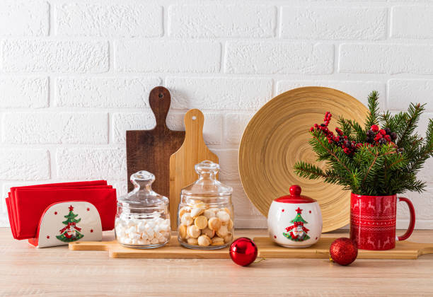istock Modern home kitchen interior concept. Spruce branches, wooden cutting boards, dishes with a New Year's pattern. Front view of the kitchen countertop. 1740368834