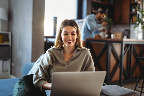 istock Home office. One smiling woman using laptop. Work, freelance, social media, technology concept. 1740371588