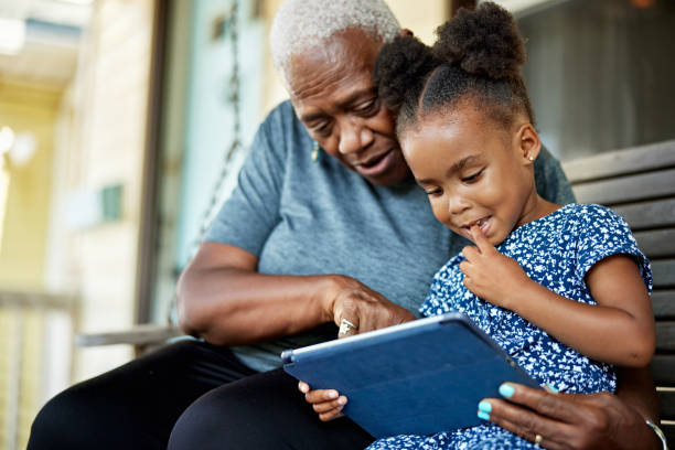 istock Senior Black woman and 4 year old child using digital tablet 1740376763