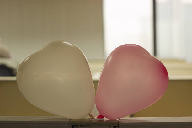 young adult female outdoors heart valentines balloons in hand