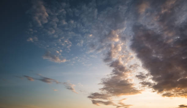 istock Minimalistic evening sky with clouds and sun glare, looking up at the sky in the evening 1740381127