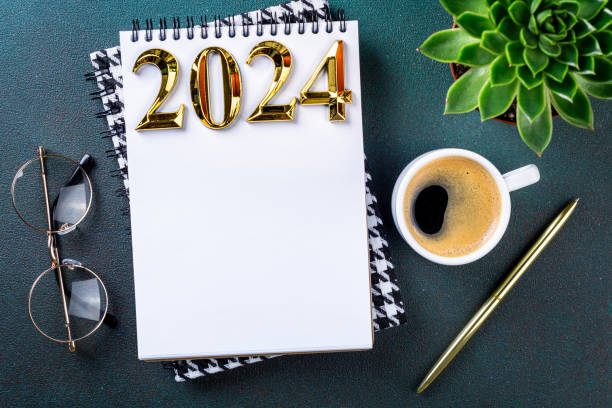 istock New year resolutions 2024 on desk. 2024 resolutions list with notebook, coffee cup on table. Goals, resolutions, plan, action, checklist concept. New Year 2024 template 1740382294