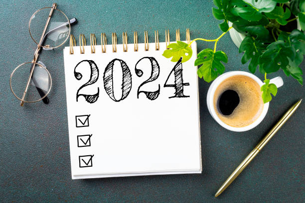 istock New year resolutions 2024 on desk. 2024 resolutions list with notebook, coffee cup on table. Goals, resolutions, plan, action, checklist concept. New Year 2024 template 1740382865