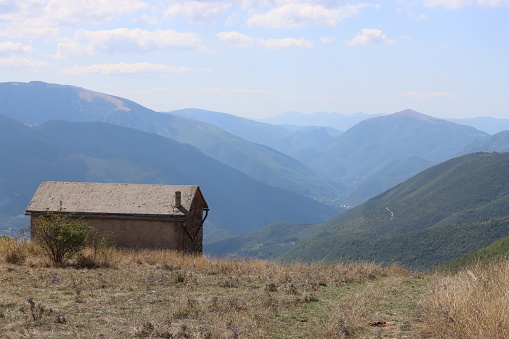 Mountain shelter overlooking green wooded hills on a clear day in summer