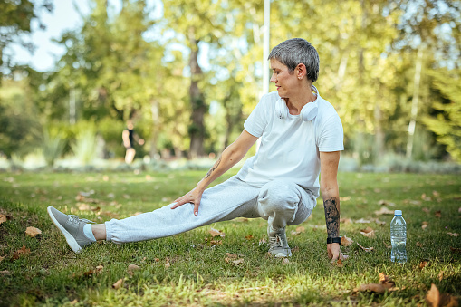 Woman doing stretching exercises in the park