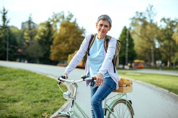 istock Woman with a bicycle in the park 1740406248