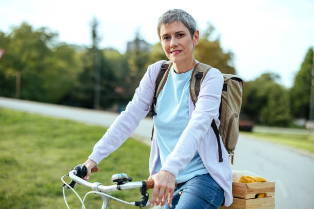 istock Woman with a bicycle in the park 1740406799