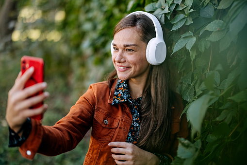 Woman listening to music and taking a selfie