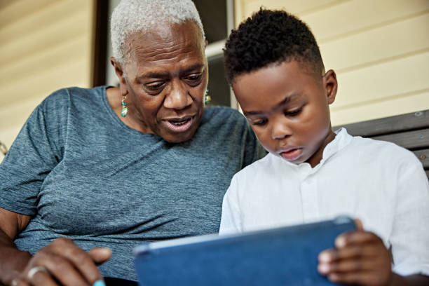 istock Close-up of Black senior and grandson using digital tablet 1740410314