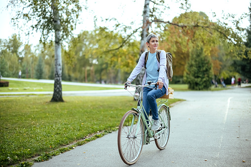 Woman rides a bicycle in the park