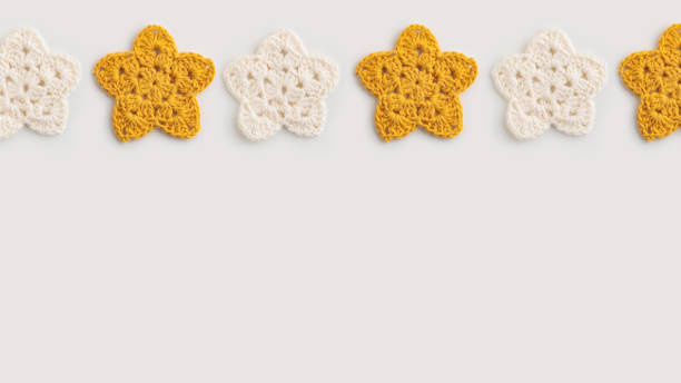 White and yellow crocheted stars pattern on a white background