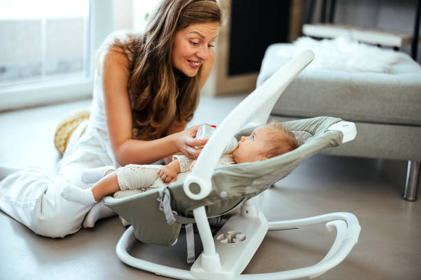 istock Mother feeds a baby with milk from a bottle 1740429863
