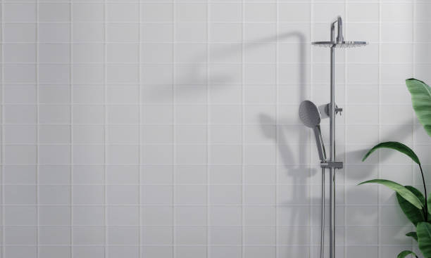 istock 3D render modern design rain shower system faucet on empty white clean marble wall in a bathroom with tropical plants, morning sunlight, beautiful blind curtains shadow. Space, Mock up, Background. 1740445281