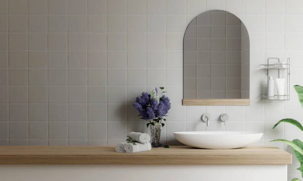 istock counter with ceramic washbasin and flower vase and modern style white bathroom 3d render, white wall and mirrors, The room has large windows. 3d render 1740448610