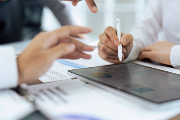 istock Two businesspeople using digital tablet and working on project together in meeting room 1740452681