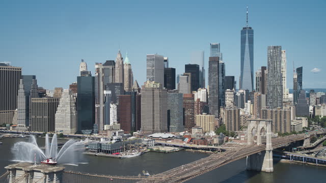 Aerial Cinematic Drone Scene Near the Manhattan and Brooklyn Bridges with NY Skyscrapers Cityscape. Beautiful Sun Shining on a Warm Summer Day. Footage of Historic Architecture