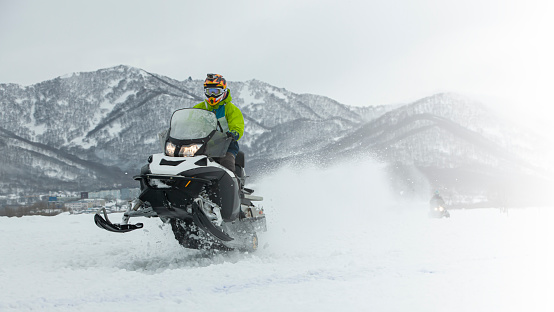 istock The Snowmobile in high jump above track. 1740469880
