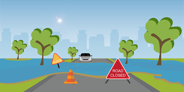 istock Flooded city road with warning sign and cones. 1740472085