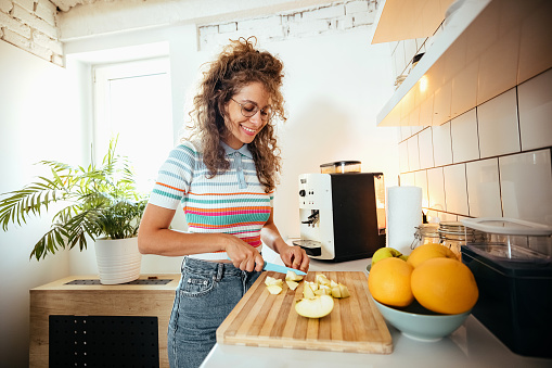 Woman cutting fruits in the kitchen