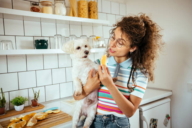 Woman in the kitchen with her dog