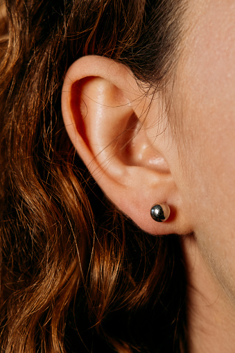 Earrings in the ear of a beautiful girl