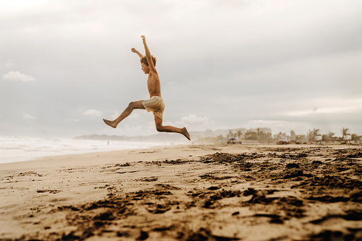 Boys jumping at the beach