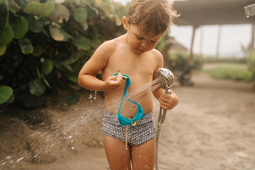 Boy Using a shower at the beach