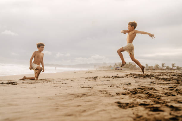 istock Boys jumping at the beach 1740492416