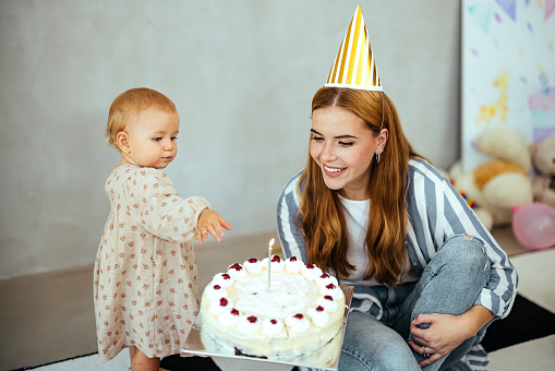 Mother and her baby girl are celebrating a birthday