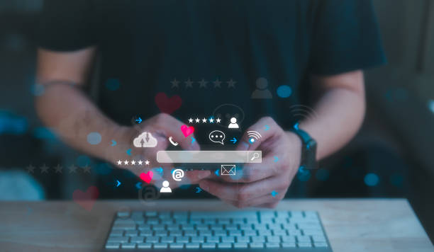 istock Social media marketing concept. man working with keyboard and using smartphone typing, chatting conversation in chat box icons pop up searching data on internet social network 1740507668
