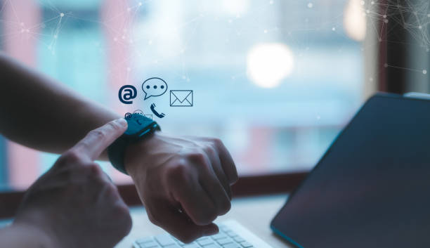 istock Social media marketing concept. a man using a generic smartwatch with a mobile phone on line for searching talking check emails calling or data analysis 1740517217