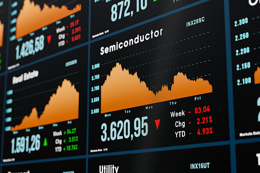 Semiconductor stocks, chart moving down. Stock market and exchange monitor with charts and industry sector trading information. 3D illustration