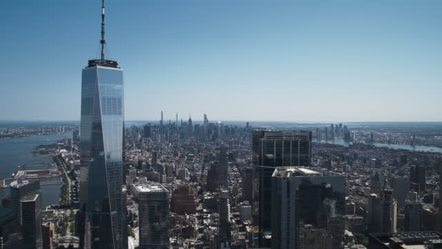 Scenic Aerial New York City View of Lower Manhattan Architecture. Panoramic Downtown Footage from a Helicopter During a Sunny Day. Cityscape with Modern Office Buildings and Historic Skyscrapers