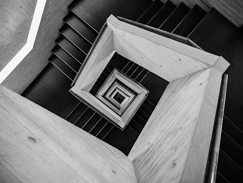 Old-fashioned spiral staircase. Black and white and low angle shot.